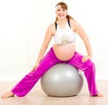 Pregnant woman doing exercises on fitness ball Royalty Free Stock Photo