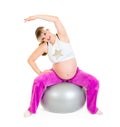 Pregnant woman doing exercises on fitness ball Royalty Free Stock Photo