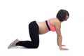 Pregnant woman doing floor exercises on white background