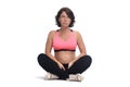 Pregnant woman doing floor exercises on white background