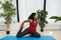 Pregnant woman doing onelegged king pigeon pose Royalty Free Stock Photo