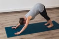 Pregnant woman doing prenatal yoga in downward facing dog posture Royalty Free Stock Photo