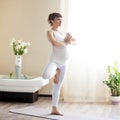 Pregnant woman doing Vrksasana yoga pose at home Royalty Free Stock Photo