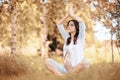 Pregnant woman doing yoga exercise in autumn Royalty Free Stock Photo