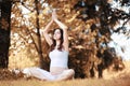Pregnant woman doing yoga exercise in autumn Royalty Free Stock Photo