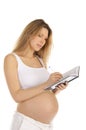 Pregnant woman down in a notebook Royalty Free Stock Photo