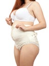 Pregnant woman dressing obstetrical binder