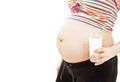 A pregnant woman drinking a glass of milk Royalty Free Stock Photo