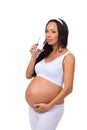 Pregnant woman drinking a glass of water isolated on white background Royalty Free Stock Photo