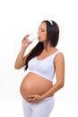 Pregnant woman drinking a glass of water isolated on white background Royalty Free Stock Photo