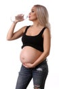 Pregnant woman drinking water. Close up. White background Royalty Free Stock Photo