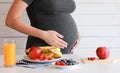 Pregnant woman eat fruit, juice, healthy food Royalty Free Stock Photo