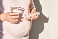 Pregnant woman eat pregnancy pills. Flu supplements. Taking allergy drugs. Royalty Free Stock Photo