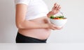 Pregnant woman eat vegetable salad, healthy food Royalty Free Stock Photo