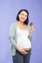 Pregnant woman eating bar of chocolate Royalty Free Stock Photo