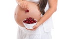 Pregnant woman eating cherries Royalty Free Stock Photo