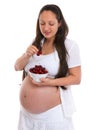 Pregnant woman eating cherries Royalty Free Stock Photo