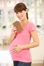 Pregnant woman eating chocolate Royalty Free Stock Photo
