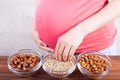 Pregnant woman eating different seeds Royalty Free Stock Photo