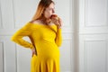 Pregnant woman eating fatty hamburger indoors at home Royalty Free Stock Photo