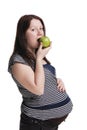 pregnant woman eating a green apple Royalty Free Stock Photo