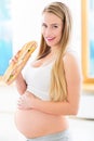 Pregnant woman eating huge sandwich