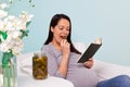 Pregnant woman eating a pickled gherkin.