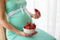 Pregnant woman eating strawberries Royalty Free Stock Photo