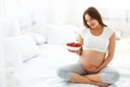 Pregnant Woman Eating Strawberry at home. Healthy Food Concept. Royalty Free Stock Photo