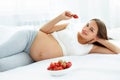 Pregnant Woman Eating Strawberry at home. Healthy Food Concept. Royalty Free Stock Photo