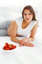 Pregnant Woman Eating Strawberry at home. Healthy Food Concept. Royalty Free Stock Photo