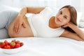 Pregnant Woman Eating Strawberry at home. Healthy Food Concept. Royalty Free Stock Photo