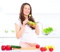 Pregnant woman eating vegetable salad