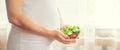 A pregnant woman eats a salad with vegetables. Selective focus Royalty Free Stock Photo