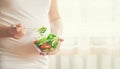 A pregnant woman eats a salad with vegetables. Selective focus Royalty Free Stock Photo