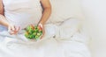 A pregnant woman eats a salad with vegetables. Selective focus Royalty Free Stock Photo