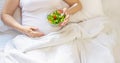 A pregnant woman eats a salad with vegetables. Selective focus Royalty Free Stock Photo