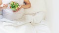 A pregnant woman eats a salad with vegetables. Selective focus Royalty Free Stock Photo