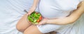 A pregnant woman eats a salad with vegetables. Selective focus Royalty Free Stock Photo