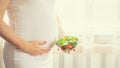 A pregnant woman eats a salad with vegetables. Selective focus Royalty Free Stock Photo