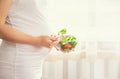 A pregnant woman eats a salad with vegetables. Selective focus Royalty Free Stock Photo