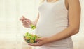 A pregnant woman eats a salad with vegetables. Selective focus Royalty Free Stock Photo