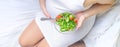 A pregnant woman eats a salad with vegetables. Selective focus Royalty Free Stock Photo