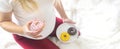 A pregnant woman eats sweet donuts. Selective Focus Royalty Free Stock Photo