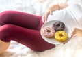 A pregnant woman eats sweet donuts. Selective Focus Royalty Free Stock Photo