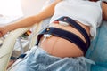 Pregnant woman with electrocardiograph check up for her baby.