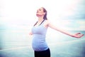 Pregnant woman embracing the sunshine