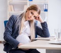 Pregnant woman employee in the office