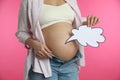 Pregnant woman with empty paper thought cloud on pink, closeup. Choosing baby name