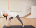 Pregnant woman is engaged in yoga. Extended Side Angle Pose or Parivrtta Parsvakonasana Royalty Free Stock Photo